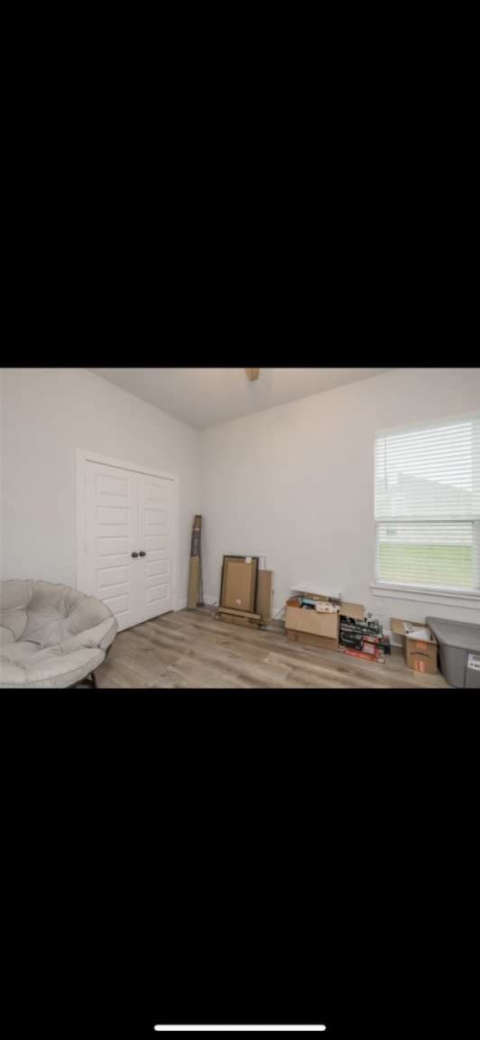 bedroom with hardwood / wood-style floors and a closet