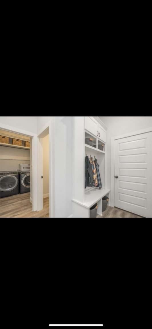 mudroom with hardwood / wood-style flooring and washer and clothes dryer