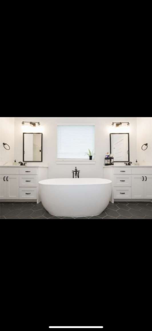 bathroom with vanity and a bathtub