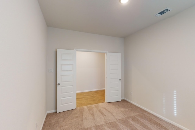 unfurnished bedroom with light colored carpet