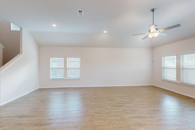 empty room featuring ceiling fan and lofted ceiling