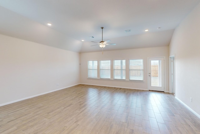 empty room with lofted ceiling and ceiling fan