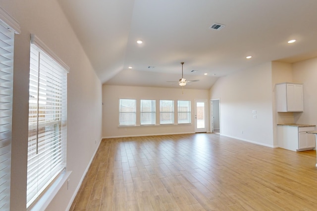 unfurnished living room with light hardwood / wood-style floors, ceiling fan, and lofted ceiling