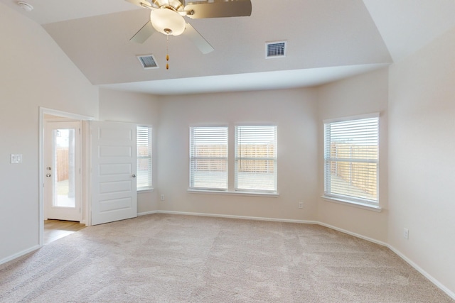 carpeted empty room with lofted ceiling, ceiling fan, and plenty of natural light