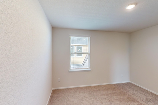 empty room featuring light colored carpet