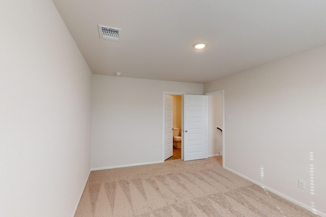 unfurnished room featuring light colored carpet