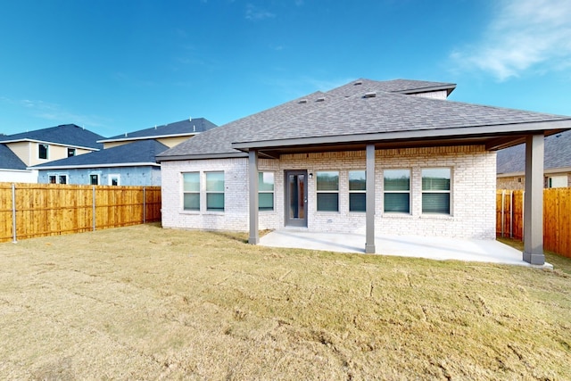 rear view of property with a patio and a yard