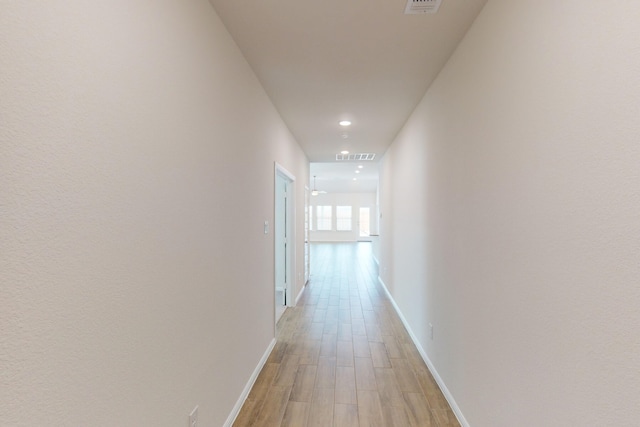 hall with light hardwood / wood-style floors