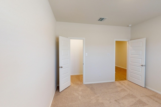 unfurnished bedroom with light colored carpet