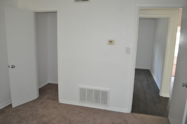 unfurnished bedroom with a closet and carpet