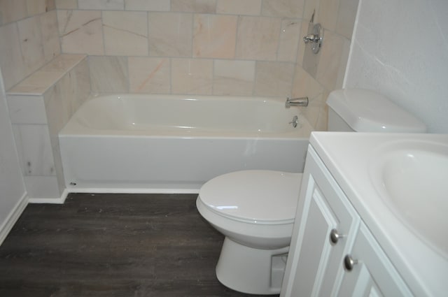 full bathroom featuring washtub / shower combination, toilet, hardwood / wood-style flooring, and vanity