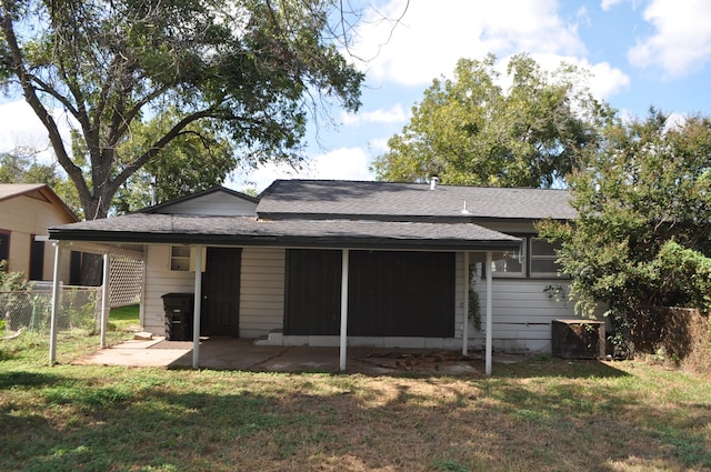 rear view of house with a yard and a patio