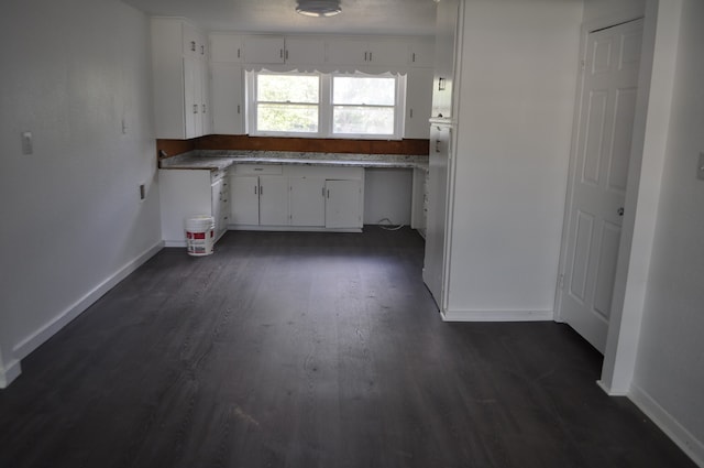 kitchen with dark wood-type flooring and white cabinetry