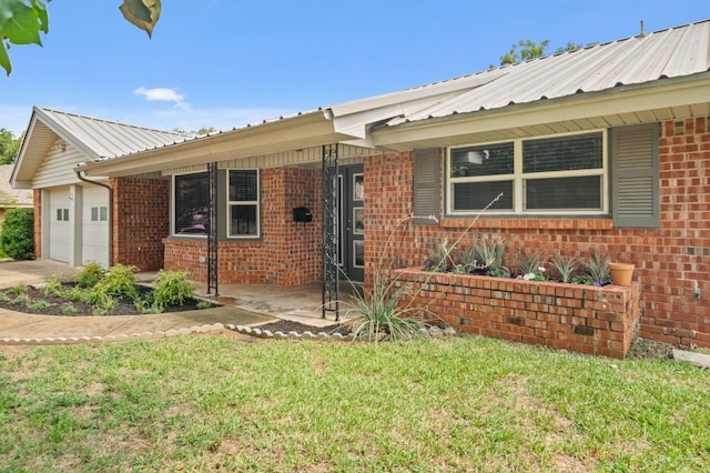 ranch-style home with a garage and a front yard