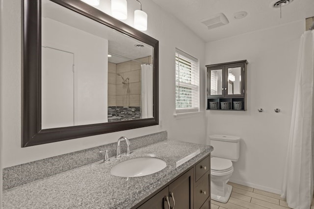 bathroom with vanity, toilet, and curtained shower