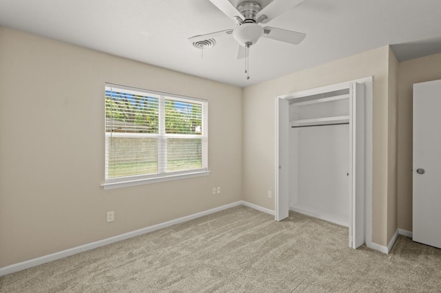 unfurnished bedroom with light colored carpet, ceiling fan, and a closet