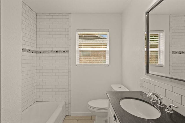 full bathroom featuring tiled shower / bath combo, vanity, toilet, and tile patterned floors