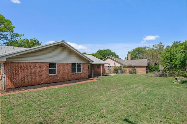 back of property featuring a yard