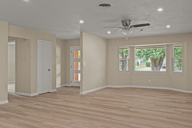 spare room featuring light hardwood / wood-style flooring and ceiling fan