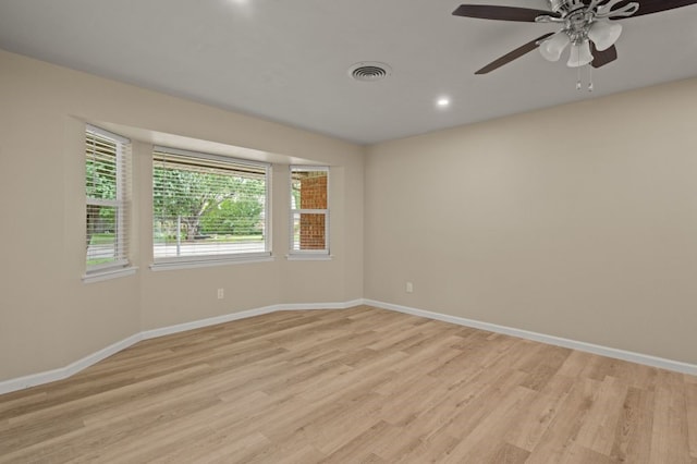 unfurnished room with ceiling fan and light wood-type flooring