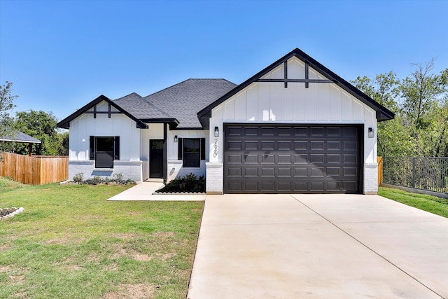 modern inspired farmhouse with a garage and a front lawn