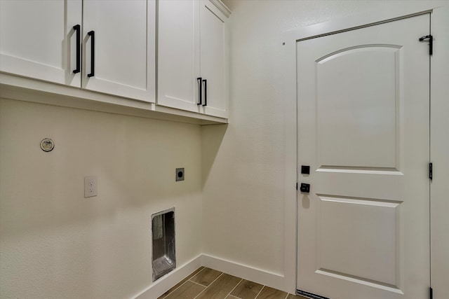 laundry area with cabinets, hardwood / wood-style floors, and hookup for an electric dryer