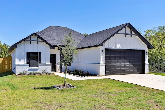 modern farmhouse featuring a garage and a front lawn