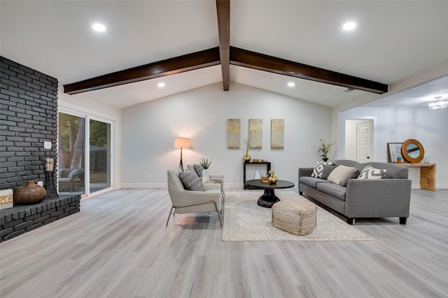 living room with vaulted ceiling with beams and light hardwood / wood-style flooring