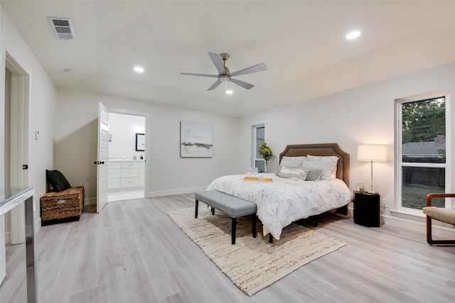 bedroom with ensuite bath, ceiling fan, and light hardwood / wood-style flooring