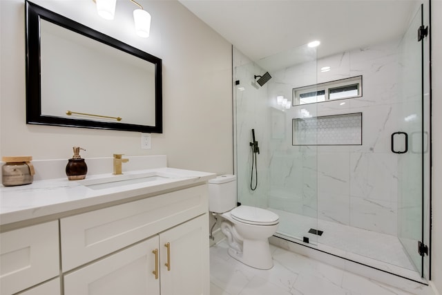 bathroom featuring vanity, toilet, and a shower with shower door