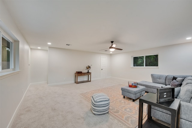 living room with light colored carpet and ceiling fan