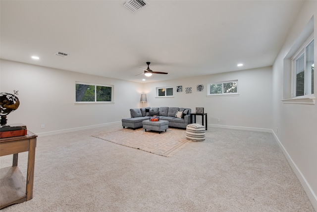 living room featuring light colored carpet and ceiling fan