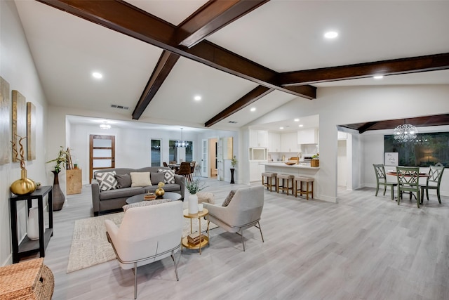 living room featuring a chandelier, light wood-type flooring, and lofted ceiling with beams