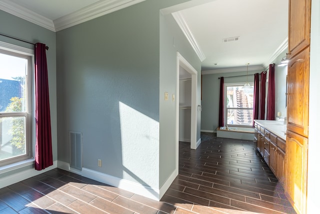 hallway with ornamental molding and dark wood-type flooring