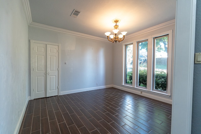 empty room with ornamental molding, a chandelier, and dark hardwood / wood-style flooring