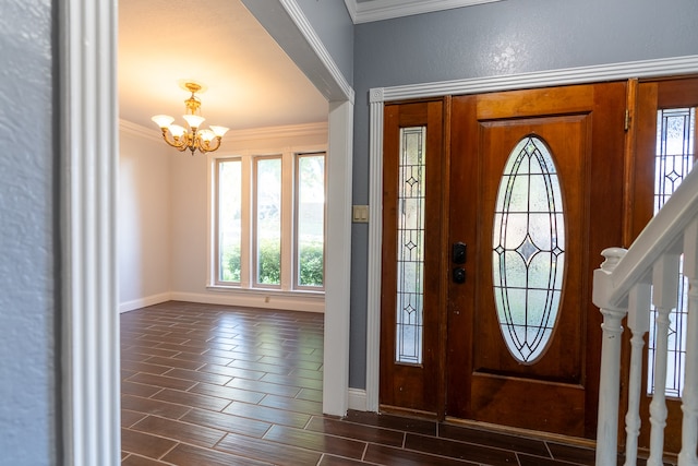 foyer with ornamental molding, an inviting chandelier, and dark wood-type flooring