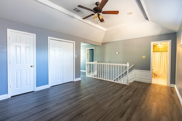 spare room featuring a raised ceiling, dark hardwood / wood-style floors, and ceiling fan