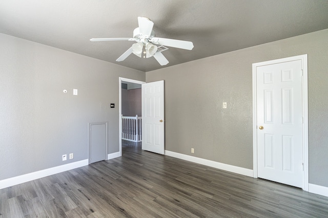 spare room featuring ceiling fan and dark hardwood / wood-style flooring