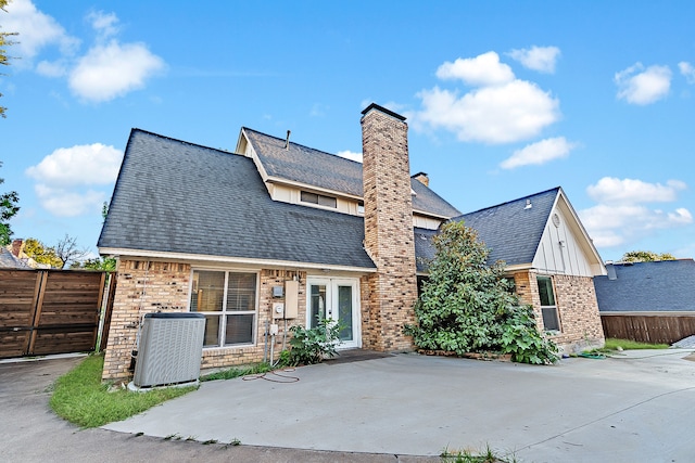 rear view of house featuring cooling unit