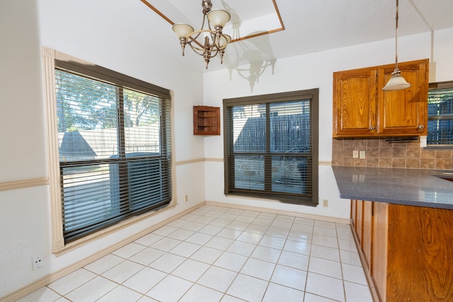 unfurnished dining area with light tile patterned floors and a chandelier