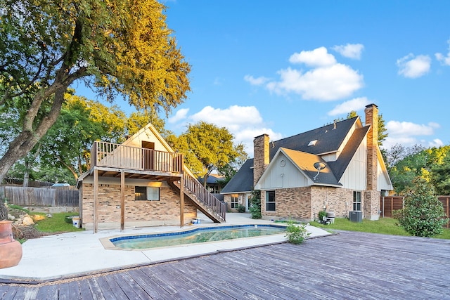 rear view of house with a patio area and a pool side deck