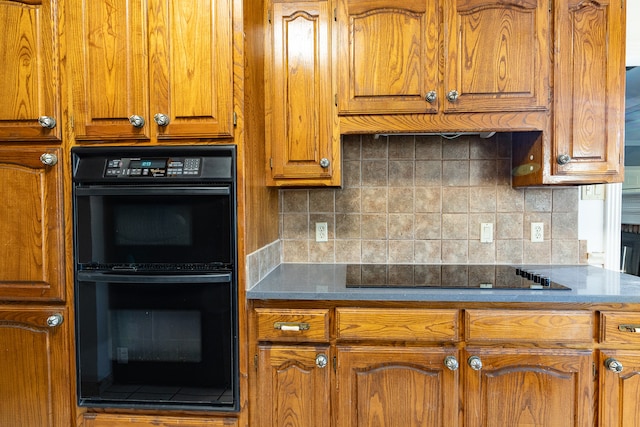 kitchen with black appliances and tasteful backsplash