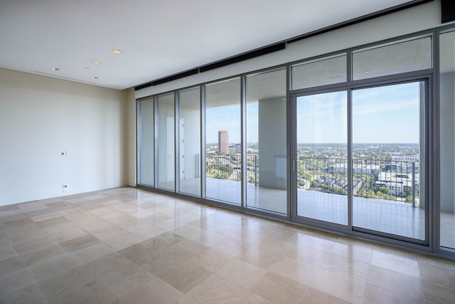 tiled spare room with floor to ceiling windows