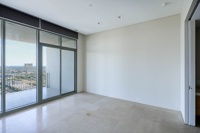 tiled spare room with expansive windows