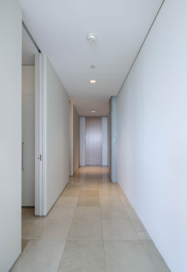 hall with light tile patterned floors