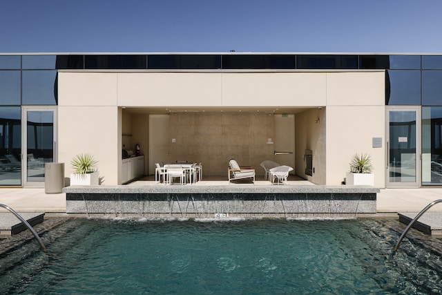 back of house featuring a patio and a community pool