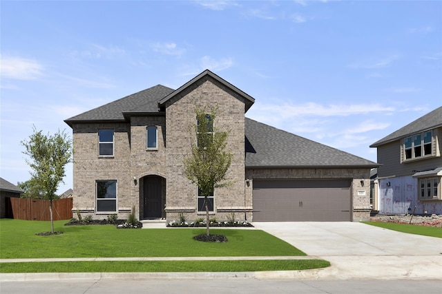 view of front of property with a garage and a front lawn