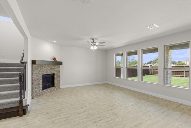 kitchen with backsplash, white cabinets, light hardwood / wood-style flooring, an island with sink, and stainless steel appliances