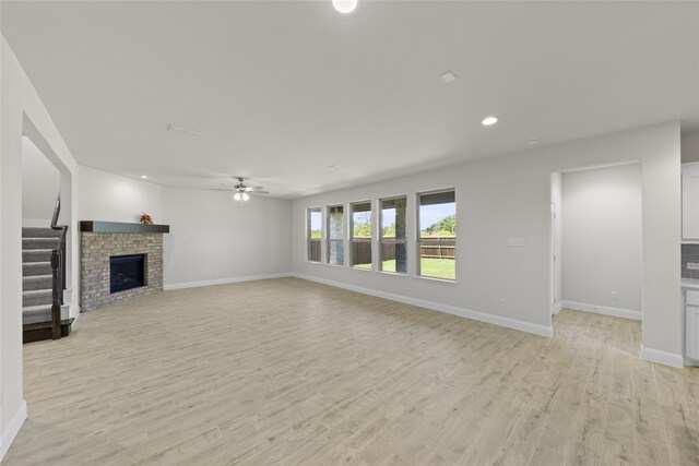 unfurnished bedroom featuring a spacious closet, light colored carpet, lofted ceiling, and a closet