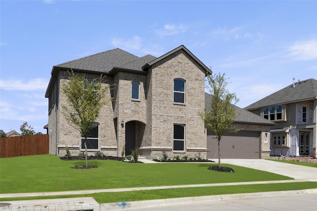 view of front of house with a front yard and a garage